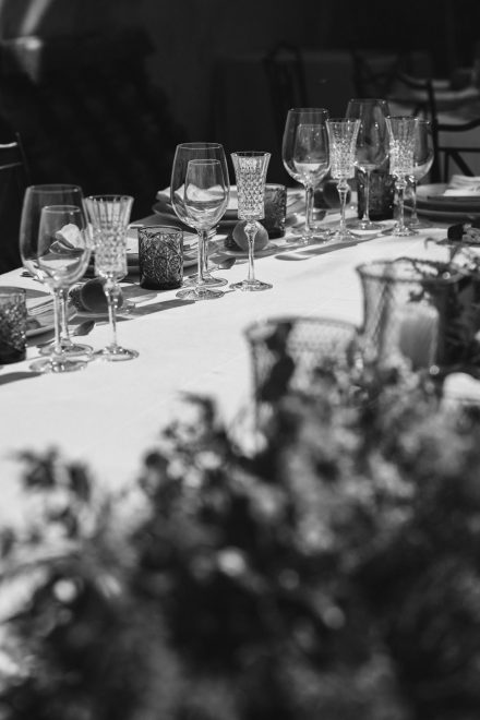 Black and white detail photo of the banquet table with cutlery set.